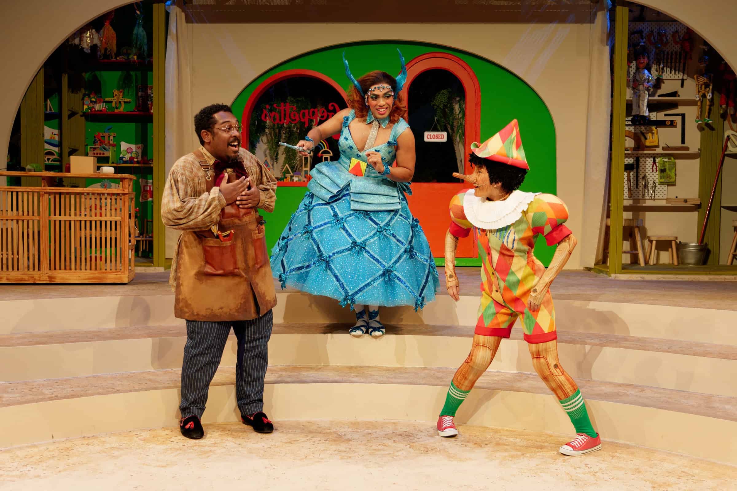 Geppetto (Ebi Shankara), Blue Fairy (Dwayne Lau) and Pinocchio (Mae Elliessa) in Geppetto's shop