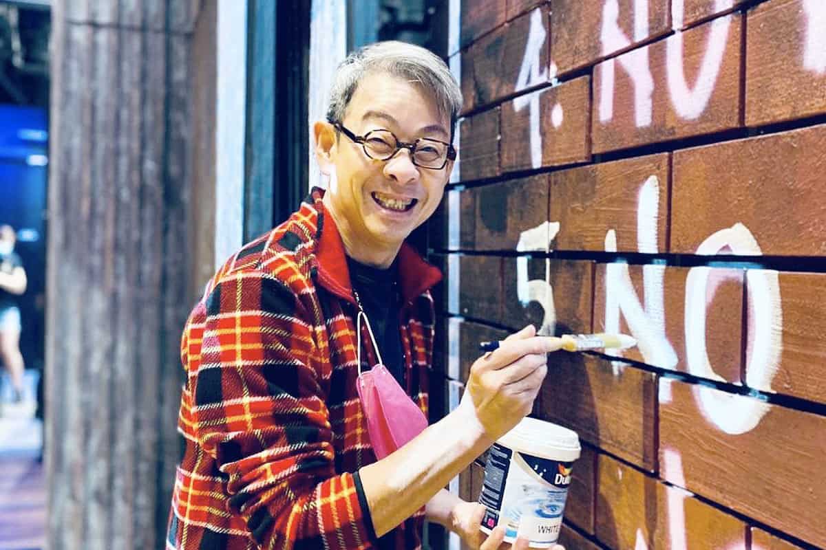 Ivan Heng painting the set of Animal Farm